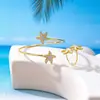 Set de 2 Piezas Estilo Europeo y Americano Estrella de Mar Dorada Vacaciones en la Playa Pulsera y Anillo Versátiles de Personalidad con un Toque de Lujo