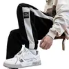 Pantalones de estilo americano para hombre, sensación de diseñador, nicho, rayas blancas y negras, buena caída, sensación de alta gama, holgados, con puño, pantalones de chándal con forro polar