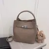Bolsa Saco Tendência Estilo Coreano para Mulheres 2026 Nova Versátil Nicho Ombro Transversal Bolsa de Mão Moda Simples