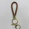 Venta al por mayor del fabricante Llavero de Cuerda de Aleación Tejida y Cuero Accesorios Colgantes Material PU Bolsas Pequeñas de Regalo Accesorios para Llaveros