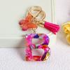 Llavero con borla de mariposa de 26 letras con pegamento de piedra de cristal y 26 letras de Creative Europe y Estados Unidos, joyería colgante.