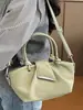 Bolso de hombro moderno y sencillo, nuevo bolso de mano para el verano de 2026, bolso tipo cubo informal de tendencia estilo coreano para mujer