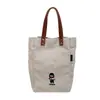 Bolsa de lona casual bordada con dibujos animados para mujer, nuevo estilo 2026, gran capacidad, adecuada para estudiantes, para ir al trabajo y versátil para el uso diario como bolso de hombro o bolso de mano