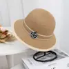 Sombrero de paja tipo pescador elegante estilo Hepburn con flor de camelia para salidas de primavera y verano, sombrero de protección solar y parasol para mujer, ropa casual