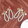 Nueva pulsera creativa de perlas con bonito colgante de aleación de corazón, llavero con cabeza de belleza, accesorios de metal, bolso de joyería para mujer