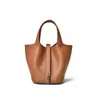 Nuevo modelo 2026 bolso cubo togo de piel de vacuno de grano superior bolso de mano de cuero genuino para mujer con un toque de alta gama