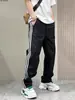 Nuevos pantalones casuales de rayas versátiles de secado rápido para primavera y otoño, pantalones largos rectos holgados de moda para hombres jóvenes, pantalones deportivos