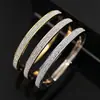 AliExpress suprimento de joias requintado brilhante estilo OL três fileiras de broca de lama branca pegajosa abertura lateral pulseira de aço titânio três cores