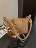 A bolsa de dumpling trançada popular deste ano para mulheres é a nova bolsa de ombro simples da moda de 2026, uma bolsa transversal de nicho estilo coreano