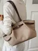 Bolsa Saco Versátil Simples de Luxo Feminina 2026 Outono Inicial Nova Tendência Estilo Coreano Exquisite Elegante Bolsinha de Mão Ombro