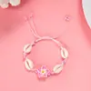 Directo de fábrica moda pequeña fresca flor de arcilla blanda concha pulsera tejida femenina joker cuerda de mano tejida a mano venta al por mayor