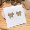 Pendientes elegantes de Dongdaemun coreanos con microincrustaciones de circonita y lazo, de plata S925, con exquisita aguja de diamantes, ideales para combinar con todo tipo de mujeres.