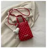 Bolsa mini para celular com pingente de coração de bolinhas cor sólida estilo coreano transfronteiriça bolsa de mão de couro macio bolsa tiracolo para meninas