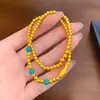 Nuevo estilo chino turquesa pez pequeño pulsera plegable cobre chapado en oro pulsera de cuerda elástica diseño joyería literaria para hombres y mujeres