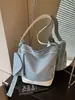 Bolsa estilo preguiçoso feminina 2026 nova bolsa de lona moda casual para trabalho deslocamento bolsa de ombro única bolsa transversal tipo balde