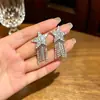Estilo europeo y americano, resistentes, aretes de borla de estrella brillantes, llamativos y adelgazantes, estrella de cinco puntas, aretes de cadena de diamantes brillantes