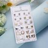 Transfronterizo Europa y Estados Unidos 12 pares de aretes de clip combinados de flores y diamantes juego de aretes personalidad una variedad de aretes de aleación