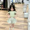 Conjunto de Duas Peças Verão 2026 Estilo Coreano para Meninas: Blusa Fresca Verde de Manga Curta e Saia Versátil Xadrez