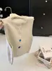 Chaleco corto de punto otoño nuevo estilo mujer simple de un solo botón corte holgado cuello redondo chaleco de punto para capas