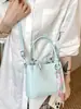 Bolso de cubo de mano minimalista de nicho Shuai Mi Jia 2026 verano nuevo estilo coreano moderno y a la moda bolso de hombro cruzado