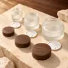 Botella de Vidrio con Grano de Madera Negra al por Mayor Botella Dispensadora de Cosméticos Botella para Crema de Mascarilla Esmerilada Botella para Crema de Ojos