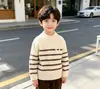 Suéter de cuello alto medio para niños de estilo transfronterizo 2026 Otoño e Invierno Nuevo estilo Suéter de rayas para niños Ropa de punto para niños