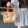 Versión coreana de mini bolsa de lona para mujer, nueva bolsa portátil de primavera y verano, versátil, simple, para el trabajo, lonchera, primera generación de cabello