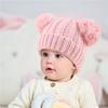 Otoño e invierno nuevo gorro de punto para niños con doble pompón Europeo y americano en stock color sólido color cálido gorro de lana para bebé