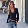 Ropa de mujer transfronteriza europea y americana otoño más vendido: Camiseta top de manga larga ajustada de color liso sexy con escote en V y cordones al por mayor