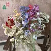 Flores artificiales de alta calidad, incluyendo arreglos florales simulados y nomeolvides, al por mayor para ventas transfronterizas, adecuadas para decoraciones de paredes de fondo de hotel y bodas