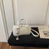 Bolsa de bolos para mujer, nuevo estilo coreano de moda primavera 2026, bolso de mano de alta gama versátil para el hombro y cruzado para el trabajo