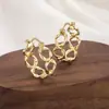 Pendientes de metal retorcido de diseño moderno, sencillo y exageradamente únicos, con un aire europeo y americano, versátiles nuevos pendientes de corazón hueco