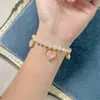 MOY Original Moda Francesa Temperamento Rosa Suave Corazón de Melocotón Forma de Corazón Piedra en Polvo Cadena de Perlas Pulsera al por Mayor