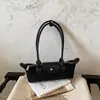 Bolsa Baguete de Luxo Discreto Francesa Moda Chic Bolsa Bolinho Transfronteiriça Uso Diário Versátil Tendência Ombro Único Bolsa de Axila