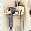 Suporte de secador de cabelo elétrico sem perfuração Prateleira de armazenamento de banheiro doméstico Suporte de parede de plástico para banheiro Venda por atacado
