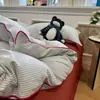 Popular juego de ropa de cama jacquard teñido en hilo lavado estilo Muji con botones de cordón, juego de cuatro piezas para dormitorio, juego de tres piezas apto para dormir sin ropa, amigable con la piel