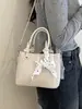 Bolso tipo cubo tote de textura tejida de nicho para mujer 2026 nuevo elegante versátil bolsa tipo cesta de verduras bolso cruzado casual