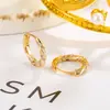 Bestseller transfronterizo: Pendientes Mobius con incrustaciones de circonita para mujer, estilo coreano sencillo, pendientes retorcidos únicos, accesorios para la oreja modernos y únicos