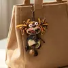 Encantador perrito peludo con la lengua fuera, llavero para bolso, colgante de dibujos animados natural, semillas de terapia de sonido curativas, popular en zonas escénicas, amuleto divertido y adorable