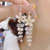Moda Japonesa y Coreana Super Hada Flor Ojo de Gato Gancho Largo para la Oreja Aretes para Mujer Versátil Borla Aretes de Celebridad de Internet Venta al por Mayor