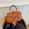 Bolso casual de color sólido 2026 nuevo retro de gran capacidad con cierre de hebilla de metal para ir al trabajo, cruzado y debajo del brazo para mujer