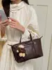 Colección nueva Otoño 2026: bolso de mano casual versátil con un look sofisticado, diseño simple, perfecto para ir al trabajo, y un bolso de hombro de moda, de nicho para mujer