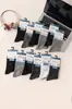 Venta al por mayor de fábrica de calcetines de algodón de longitud media para hombre y mujer, estilo business casual, para otoño e invierno, con propiedades absorbentes del sudor y transpirables, adecuados tanto para uso casual como para actividades deportivas