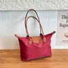 Bolsa Tote Simples de Grande Capacidade Nova Tendência Primavera 2026 Bolsa de Ombro Simples Elegante Bolsa Transversal Retrô para Mulheres