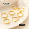 Anillo de amor de viento de metal, diseño de nicho femenino que no se desvanece, anillo hueco chapado en oro, joyería de acero de titanio geométrica de moda