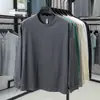 Camiseta Casual de Manga Longa Masculina Primavera e Outono Roupa de Baixo Top Nova Camiseta 100% Algodão Gola Redonda Camada Base Cor Sólida Moletom Tendência