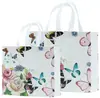 Bolsa no tejida en stock Impresión a color de película Bolso de mano para llevar ropa a domicilio Regalo publicitario Bolsa de compras promocional al por mayor