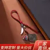 Colgante estilo tibetano colgante de cuerda tejido a mano Nueve Palacios Ocho Trigramas Placa de cobre Sparho colmillo de lobo cuenta de jade llavero al por mayor