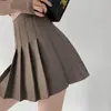 Saia plissada de cintura alta em estoque, saia curta feminina, saia de outono, estilo preppy, versão coreana, cor sólida, saia evasê anti-exposição, atacado