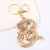 Llavero Animal Zodiacal Serpiente Colgante Pequeño Pedrería Metal Portador de Fortuna Cordón de Cuero Decoración de Año Nuevo Llavero Venta al por Mayor